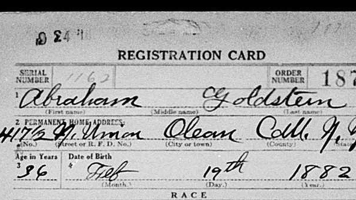 Close-up of a 1918 draft registration card showing a handwritten name, address and date of birth